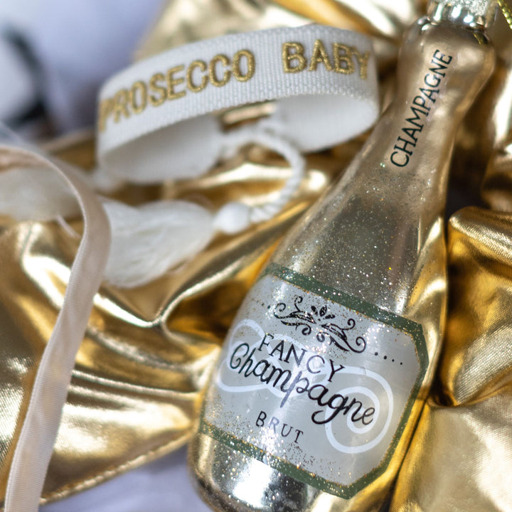 Prosecco Baby bracelet and champagne ornament from LNH Edit Golden Luxe Gift Box.