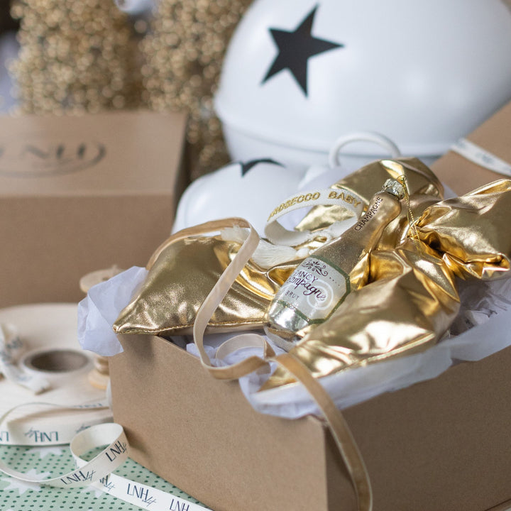 LNH Edit Golden Luxe Gift Box styled with gold holiday décor and packaging.