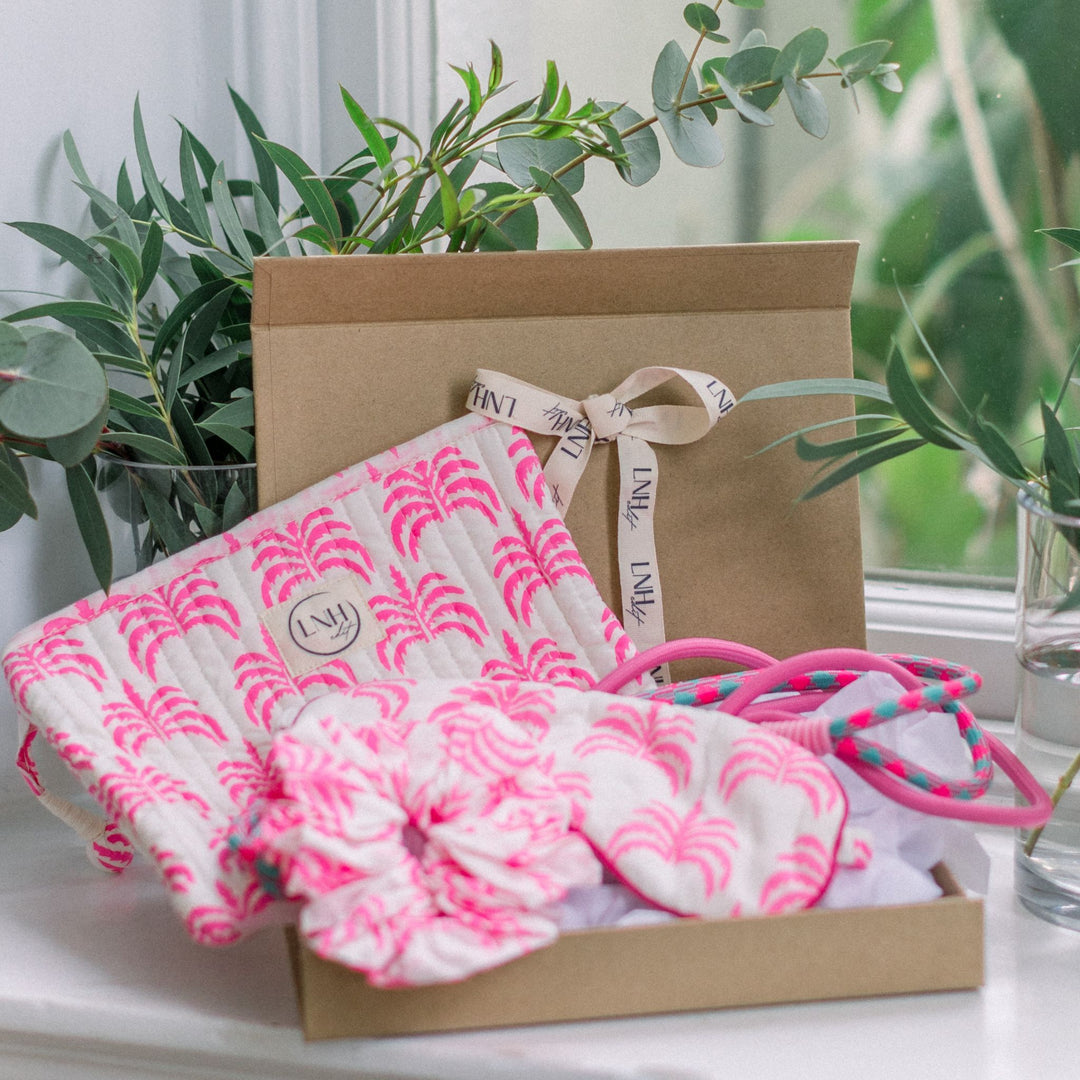 LNH Edit Pink Palm Gift Set with pouch, scrunchie, and eye mask in open kraft box.