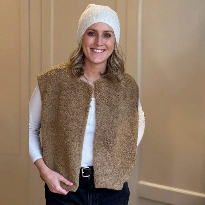 Caramel boxy fleece gilet from LNH Edit, styled by founder Laura with a white top and beanie.