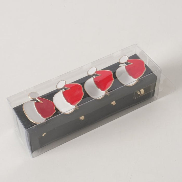 Angled view of boxed Santa hat napkin rings showing red and white enamel finish.