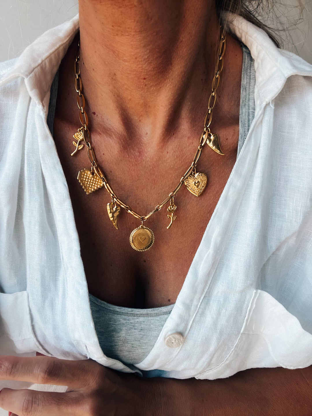 Gold charm necklace with hearts and roses