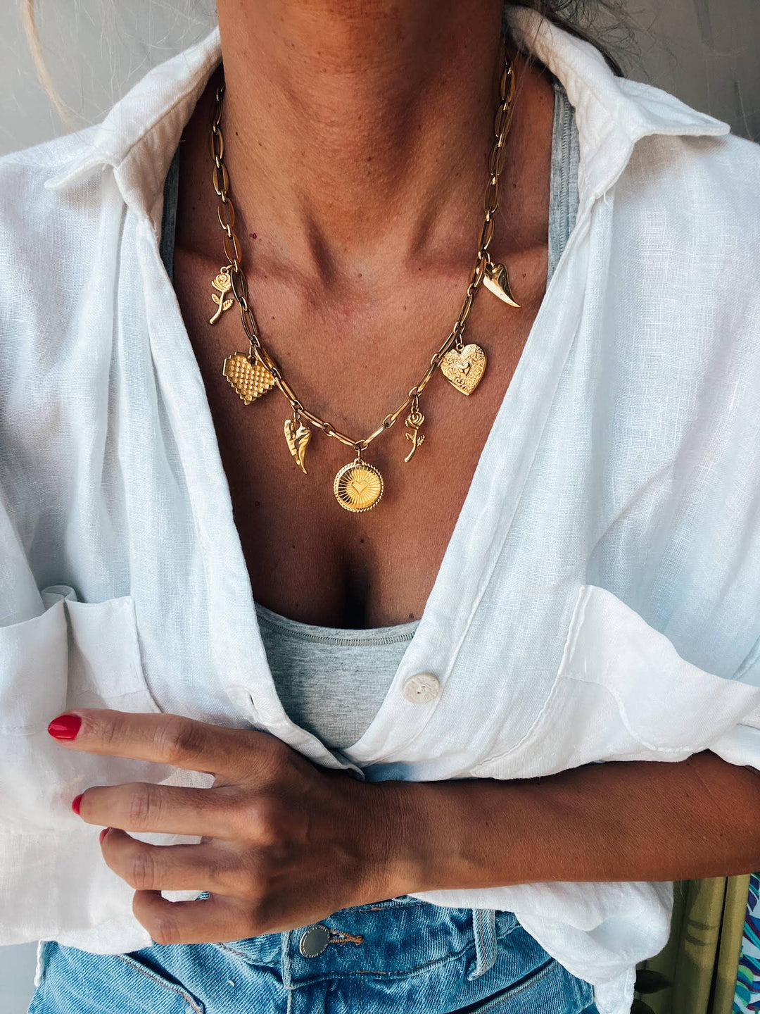 Gold charm necklace with hearts and roses