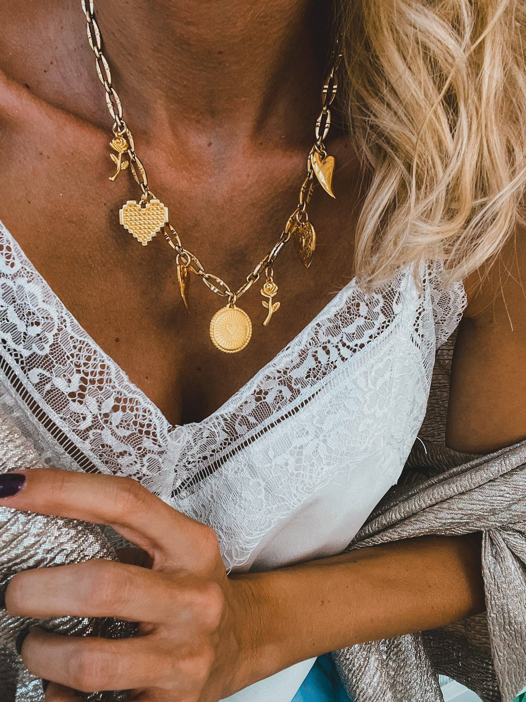 Gold charm necklace with hearts and roses