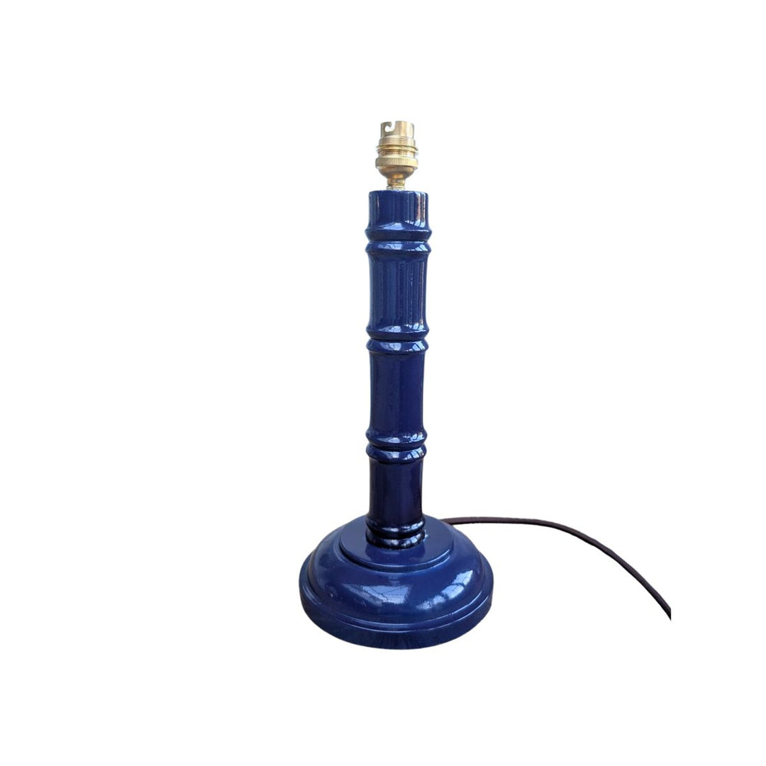 Blue hand-painted bamboo lamp base with gold bulb fitting on a white background.