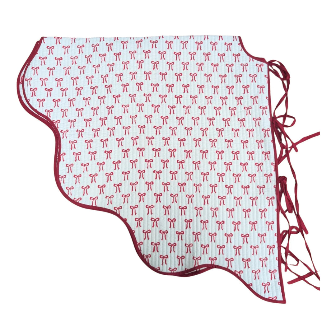 Christmas bow quilted tree skirt with scalloped edge and red bow print, handmade in Jaipur by LNH Edit.