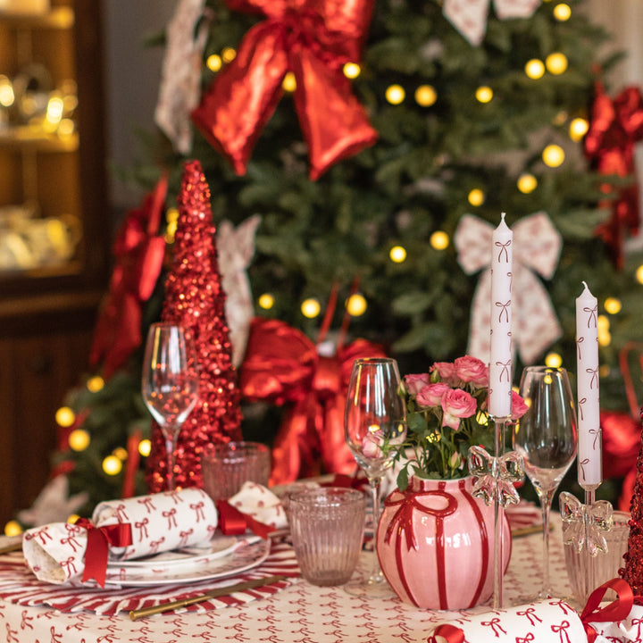 The Holly Collection red and white Christmas table styled with tree, candles, and festive décor by LNH Edit.