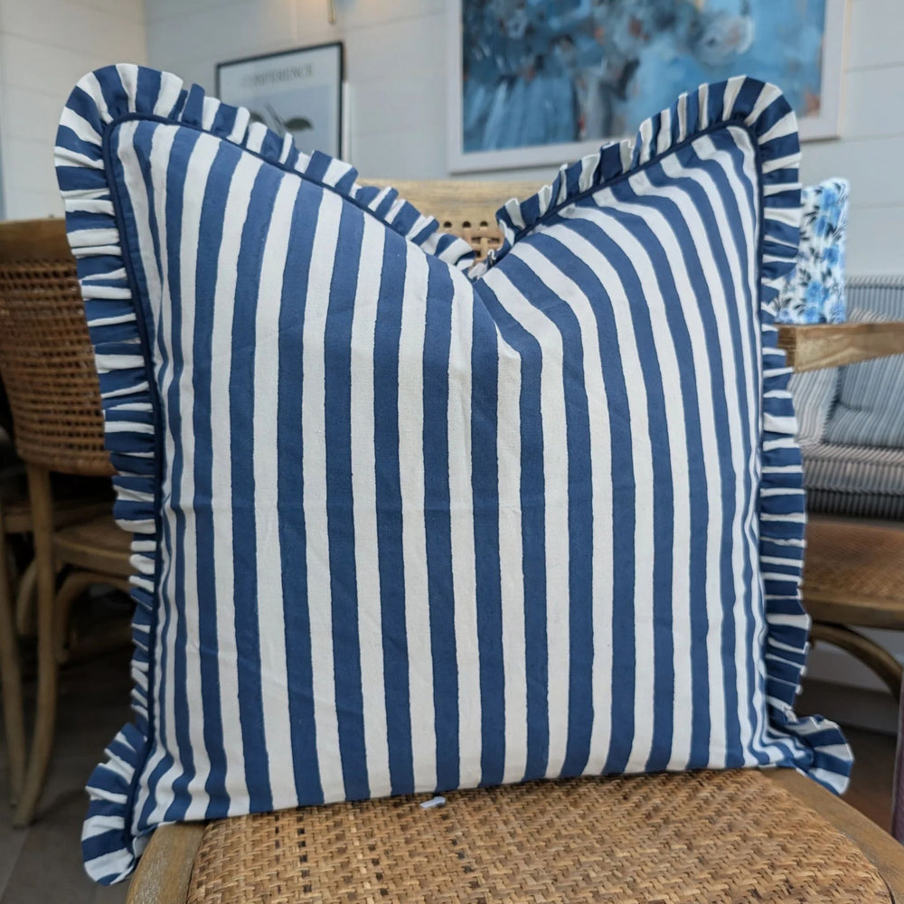 LNH Edit Iris blue and white striped cushion cover with frilled trim styled on rattan chair, hand block printed cotton.