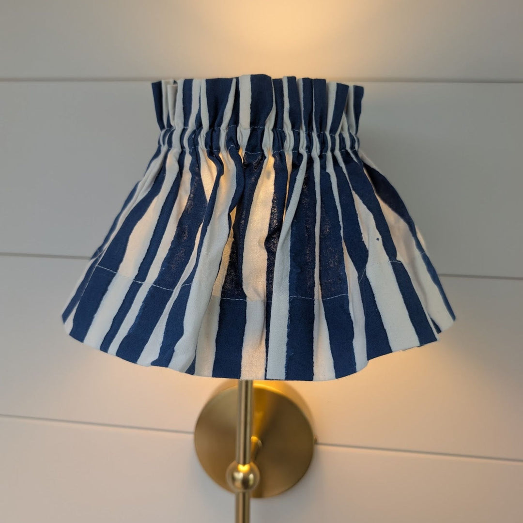 Iris Blue Stripe lampshade cover on brass wall light, block-printed cotton by LNH Edit.