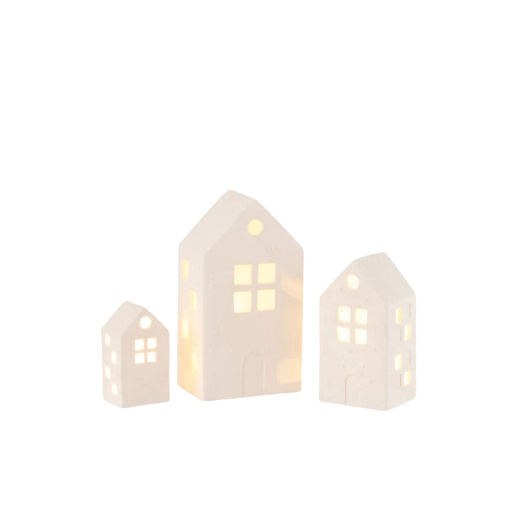 LNH Edit LED gingerbread-style white ceramic houses with glowing windows, set of three for Christmas decor.