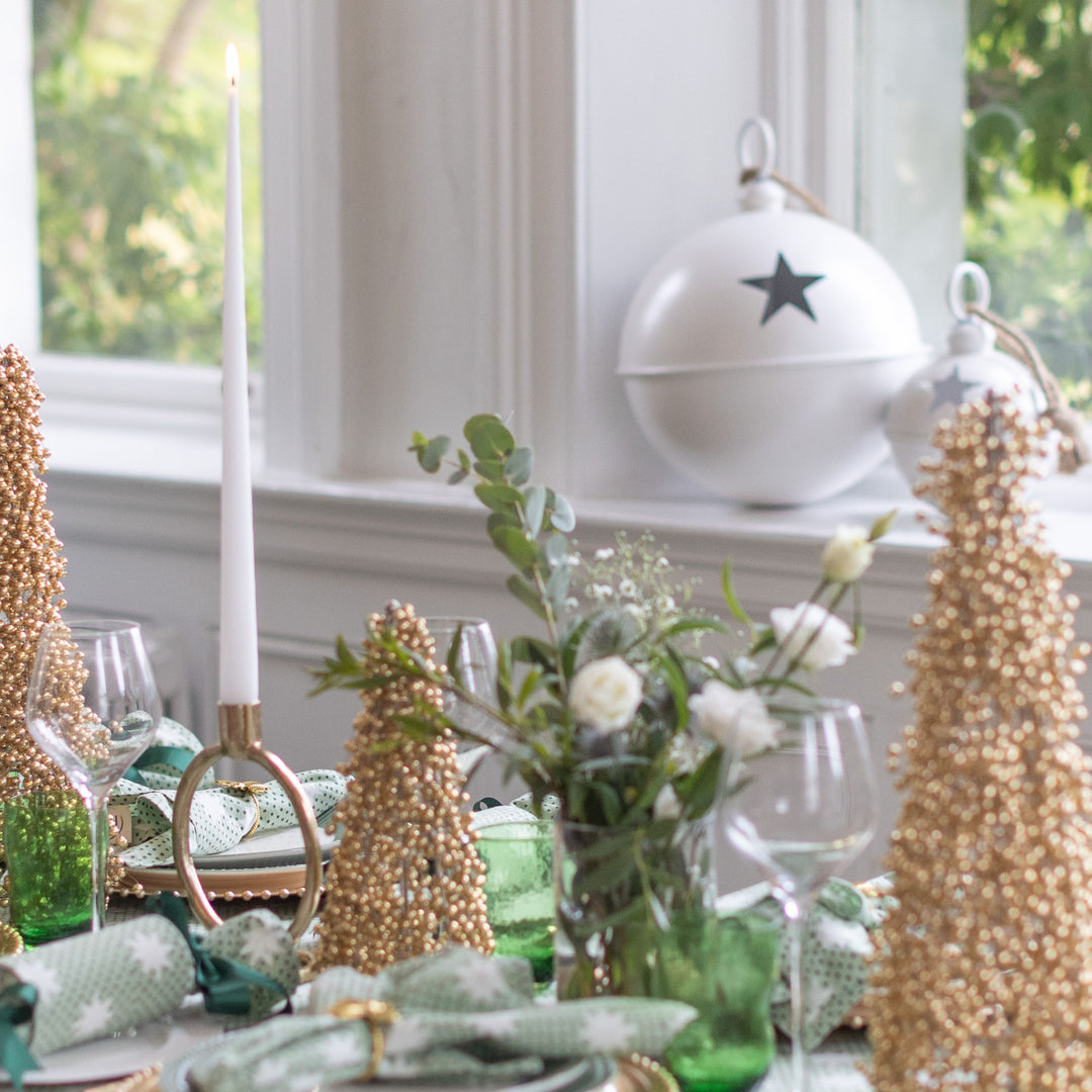 Green reusable Christmas cracker with white star print on elegant festive table by LNH Edit.