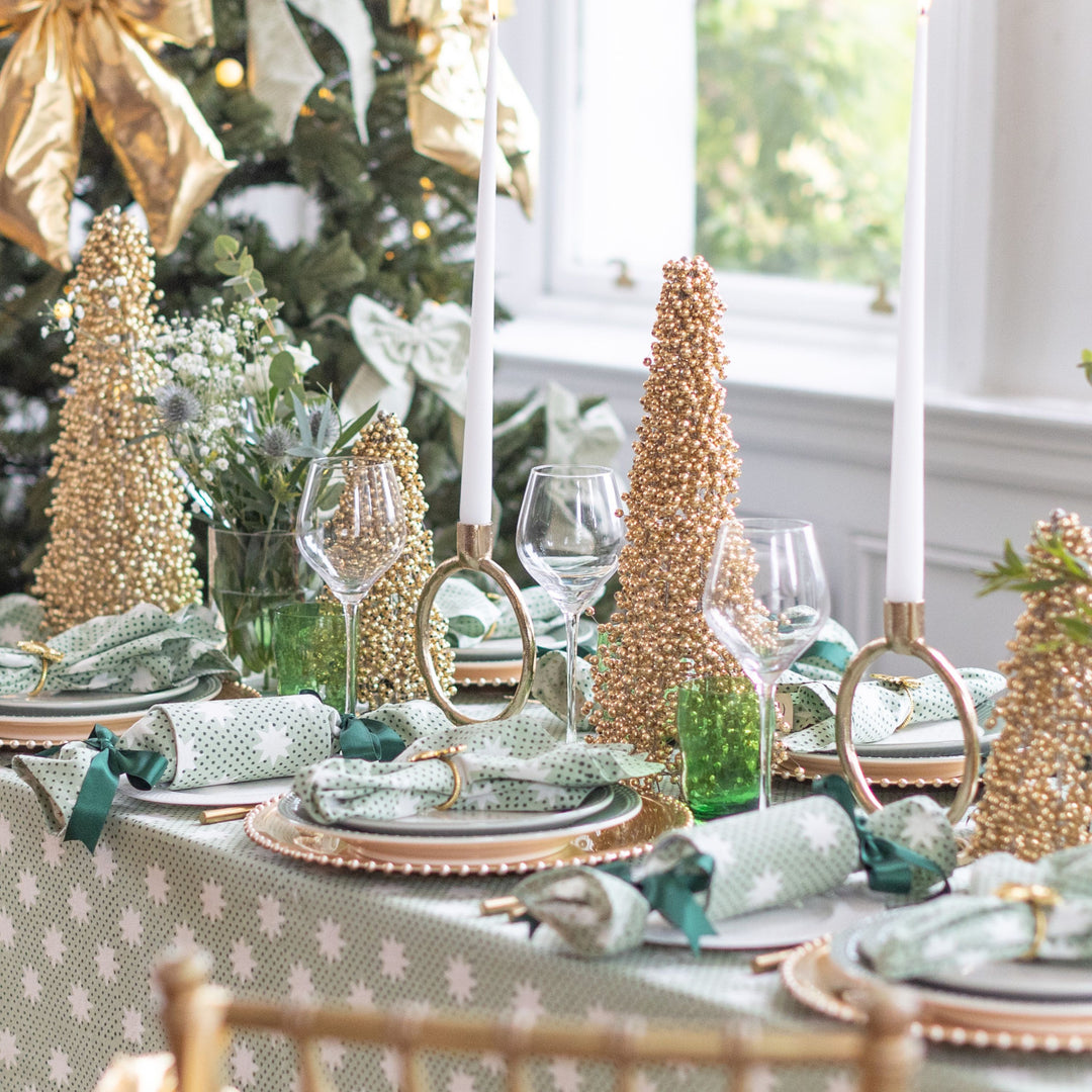 Elegant green and gold Christmas table styled with reusable crackers from The LNH Edit.