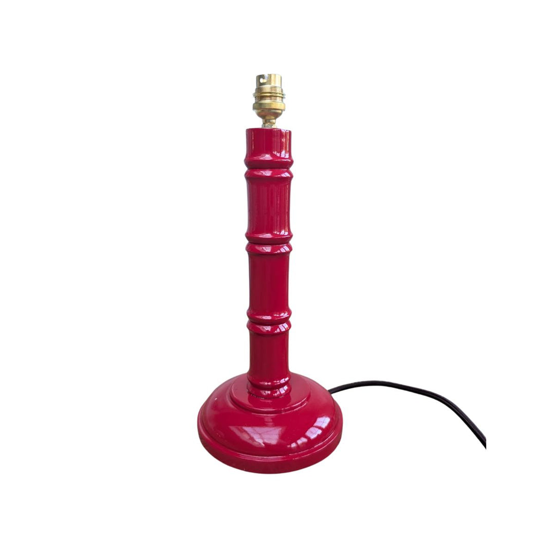 Red hand-painted bamboo lamp base with gold bulb fitting on a white background.