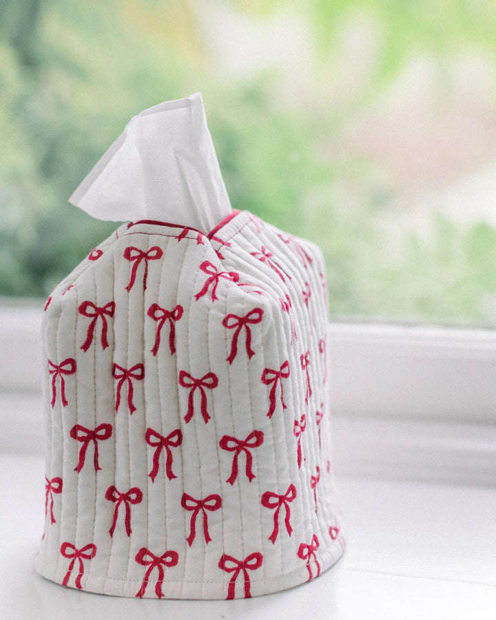 Quilted red bow cotton tissue box cover styled on a windowsill, handcrafted by LNH Edit.