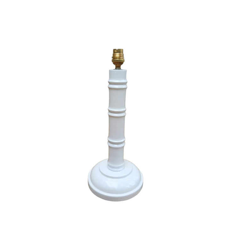 White hand-painted bamboo lamp base with gold bulb fitting on a white background.