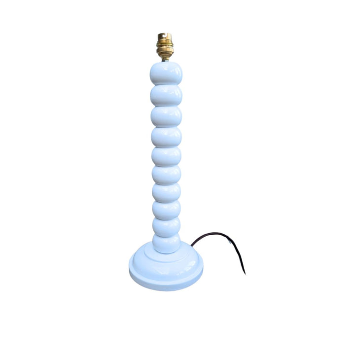 White hand-painted bobbin lamp base with gold bulb fitting on a white background.