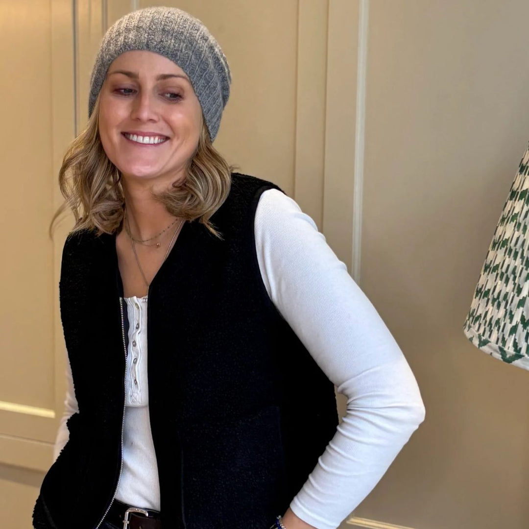 Black boxy fleece gilet from LNH Edit styled with white top and grey beanie.