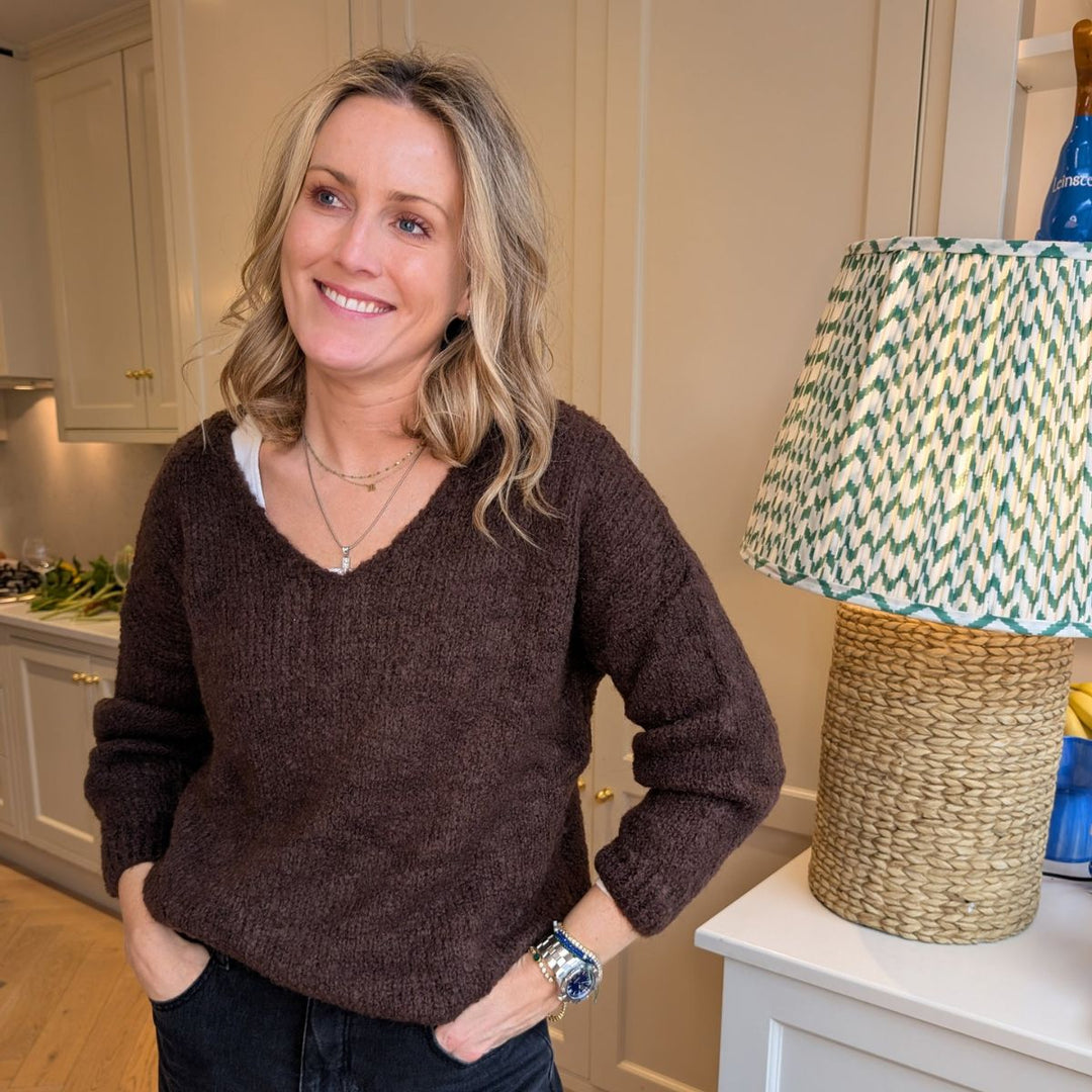 Chocolate bouclé v-neck sweater from LNH Edit, styled by founder Laura in a kitchen setting.