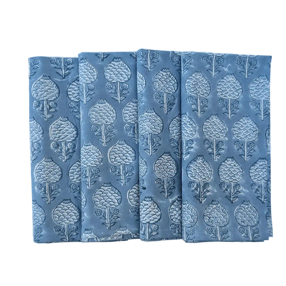 Four blue blockprinted napkins with tree pattern on a white surface