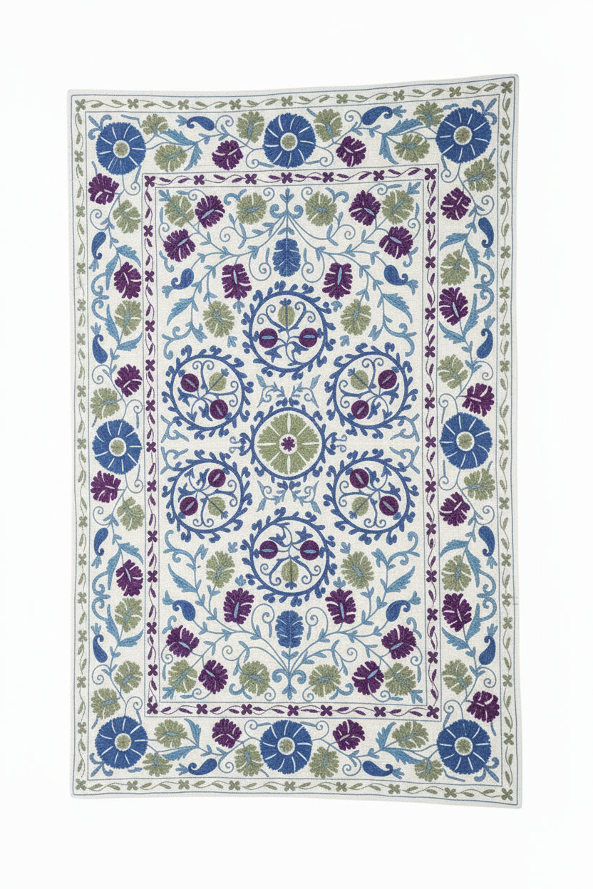 Decorative floral-patterned fabric draped over a stone wall with a garden background.