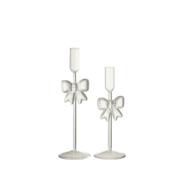 Set of two transparent glass candle holders with sculptural bow design, elegant festive décor.