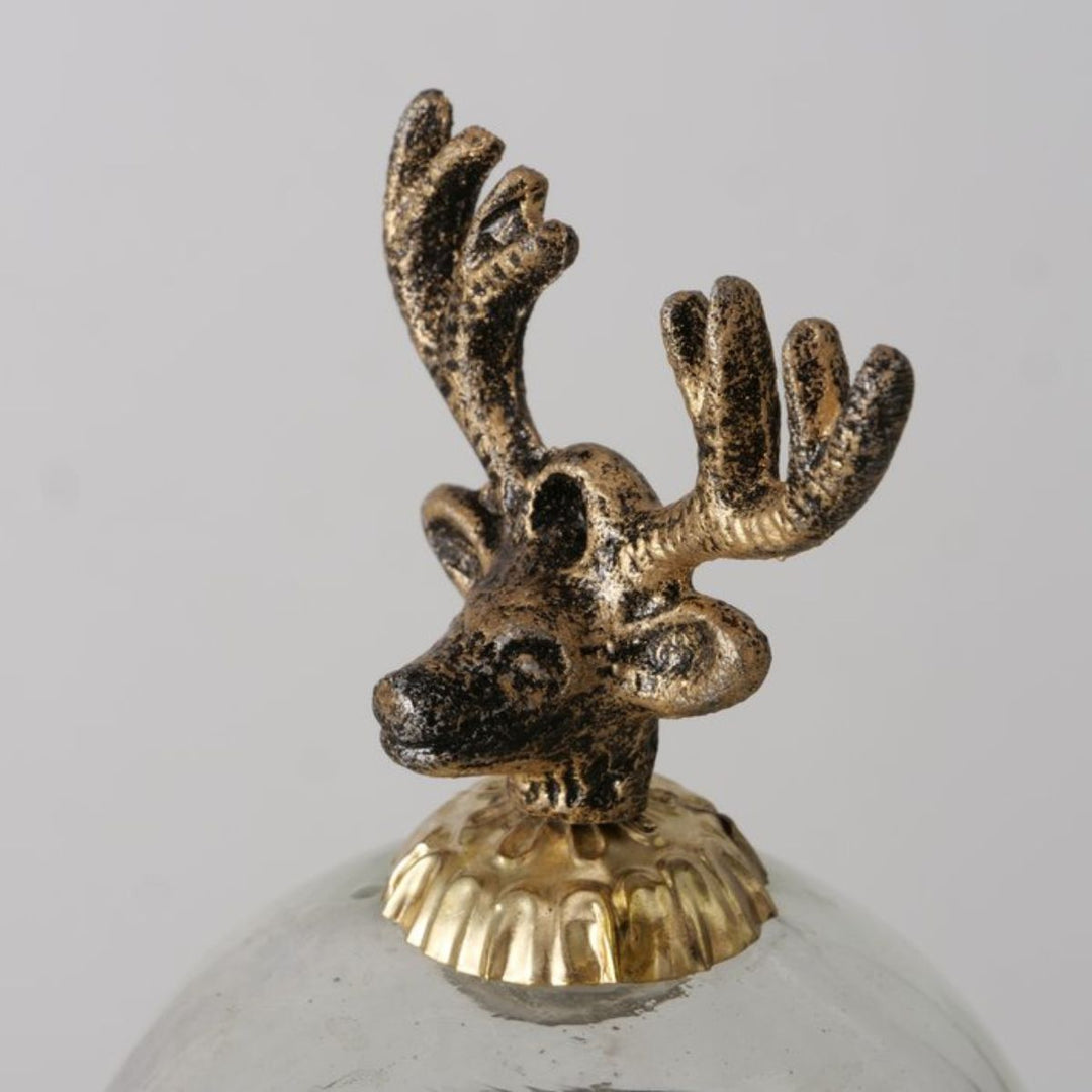 Close-up of sculptural gold reindeer lid detail, handcrafted festive design.