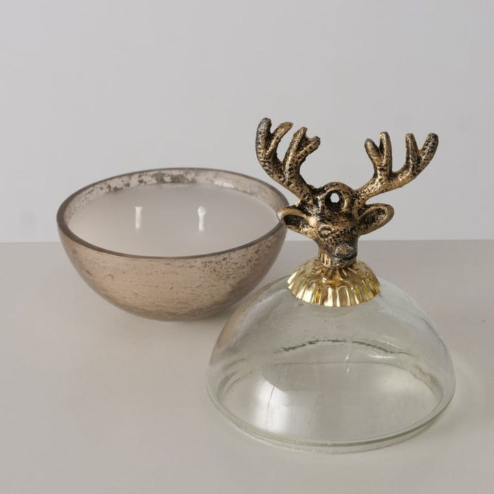 Open gold reindeer candle pot with glass lid removed, showing candle inside.
