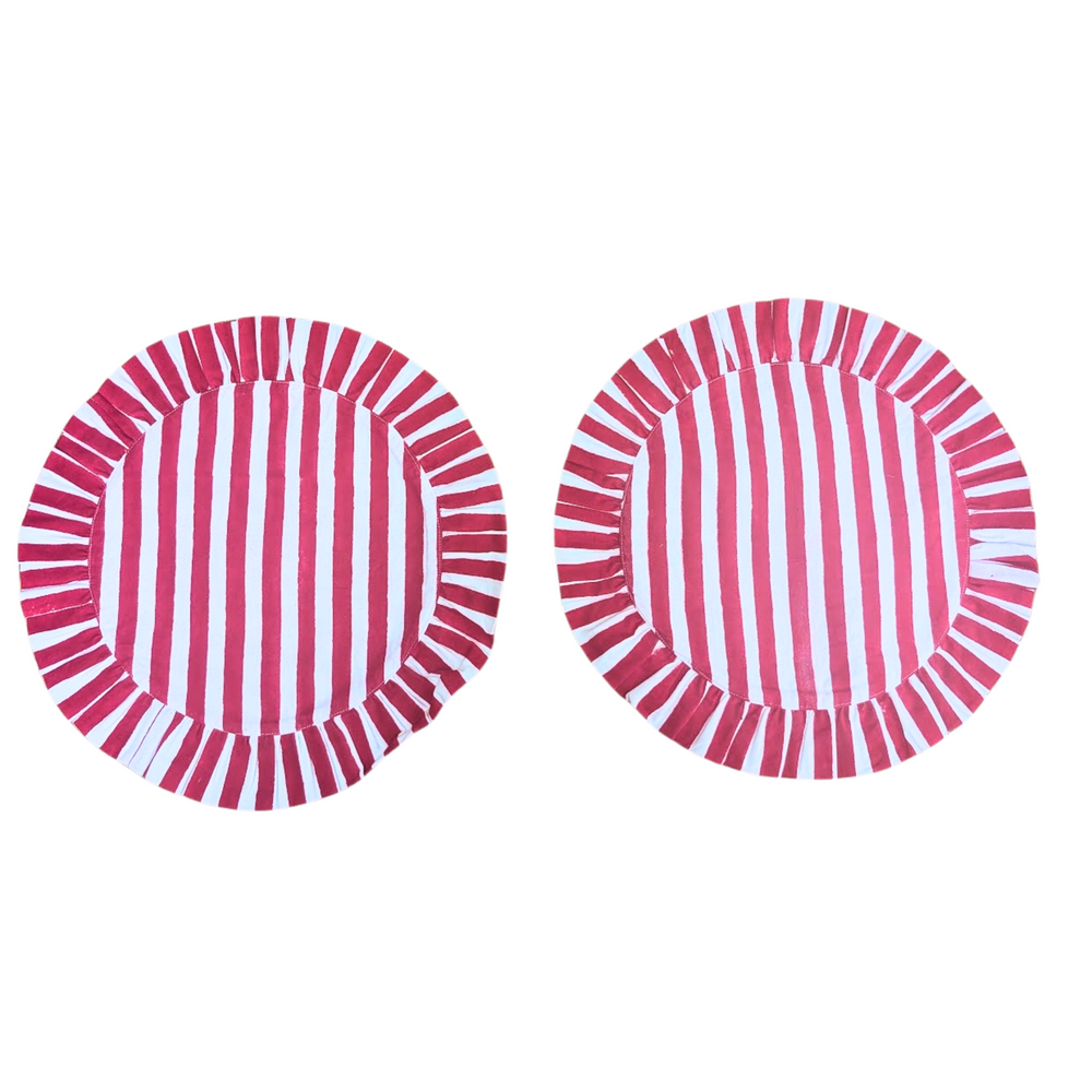 Two circular red and white striped frill placemats on a white background