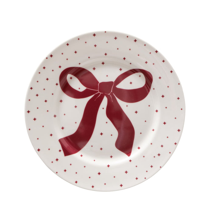 Round white ceramic plate with red bow and dotted motif from LNH Edit.