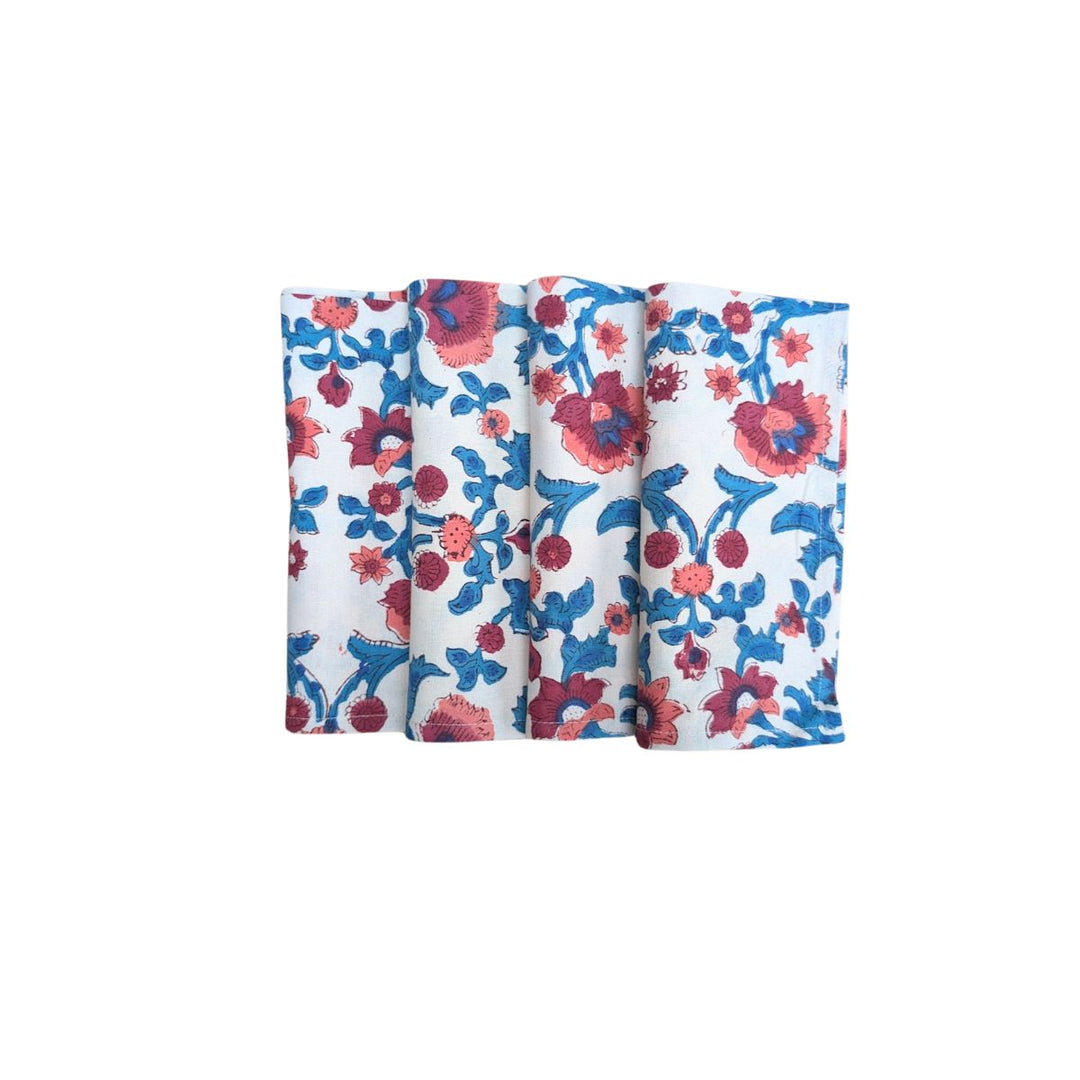 Set of four handmade block-printed cotton napkins featuring blue and burgundy floral pattern on white background.