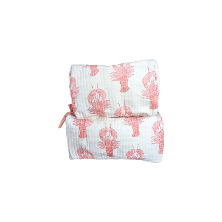 Set of two quilted cotton cosmetic bags with coral lobster print on white fabric.