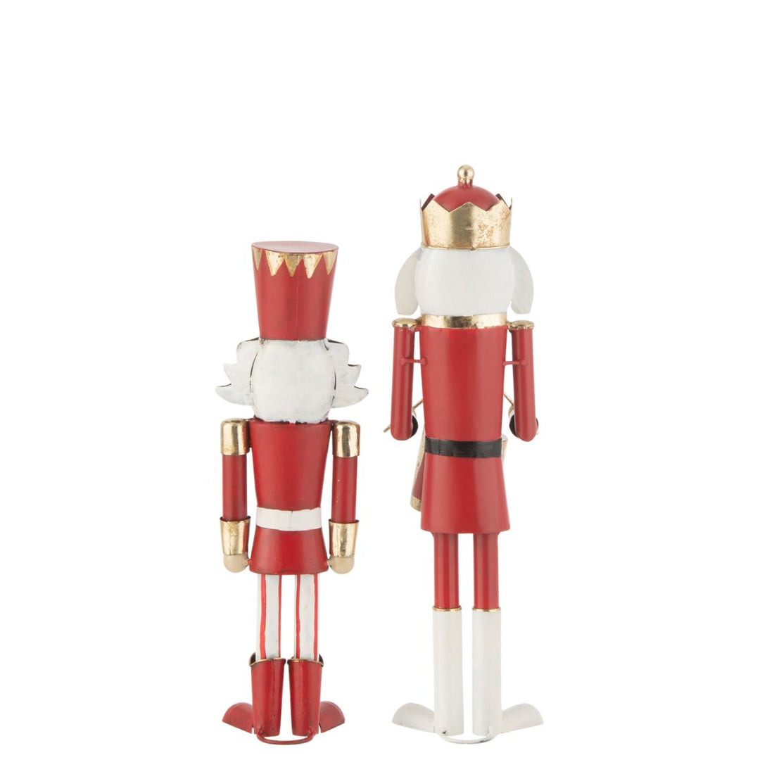 Back view of two red and gold nutcracker figures showing painted details.