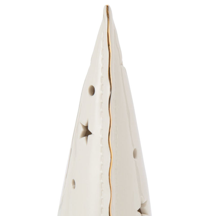 Close-up of gold-edged white ceramic LED tree with star-shaped cut-outs.