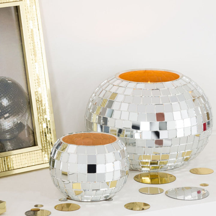 Silver mosaic tealight holder styled on a shelf with matching large holder and gold accents.