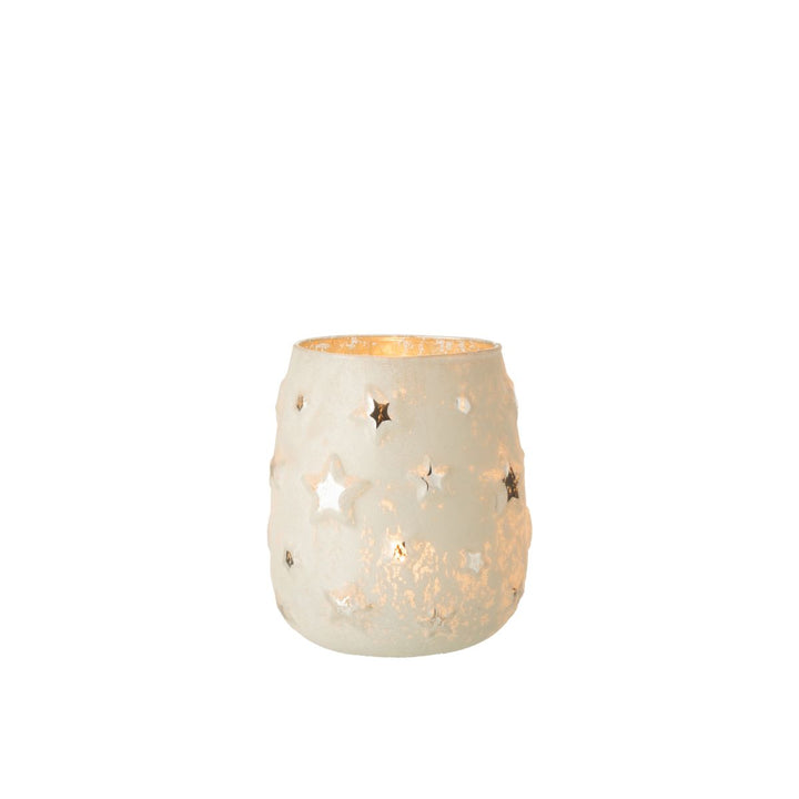 Star cut-out glass tealight holder glowing warmly.