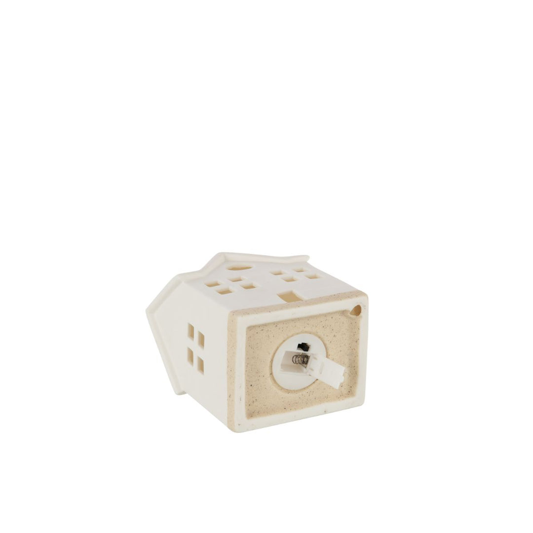 Bottom view of white ceramic LED house showing battery compartment.